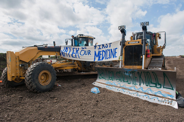 Signs hang from heavy machinery after protesters stopped construction on the Energy Transfer Partners Dakota Access oil pipeline near the Standing Rock Sioux reservation in Cannon Ball, North Dakota